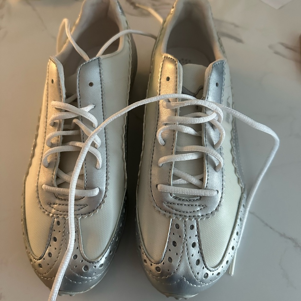Puma Women's Silver and Cream golf shoes never worn. Size seven.